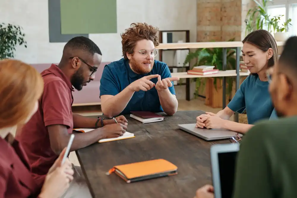 Business team discussing plans together around a meeting table